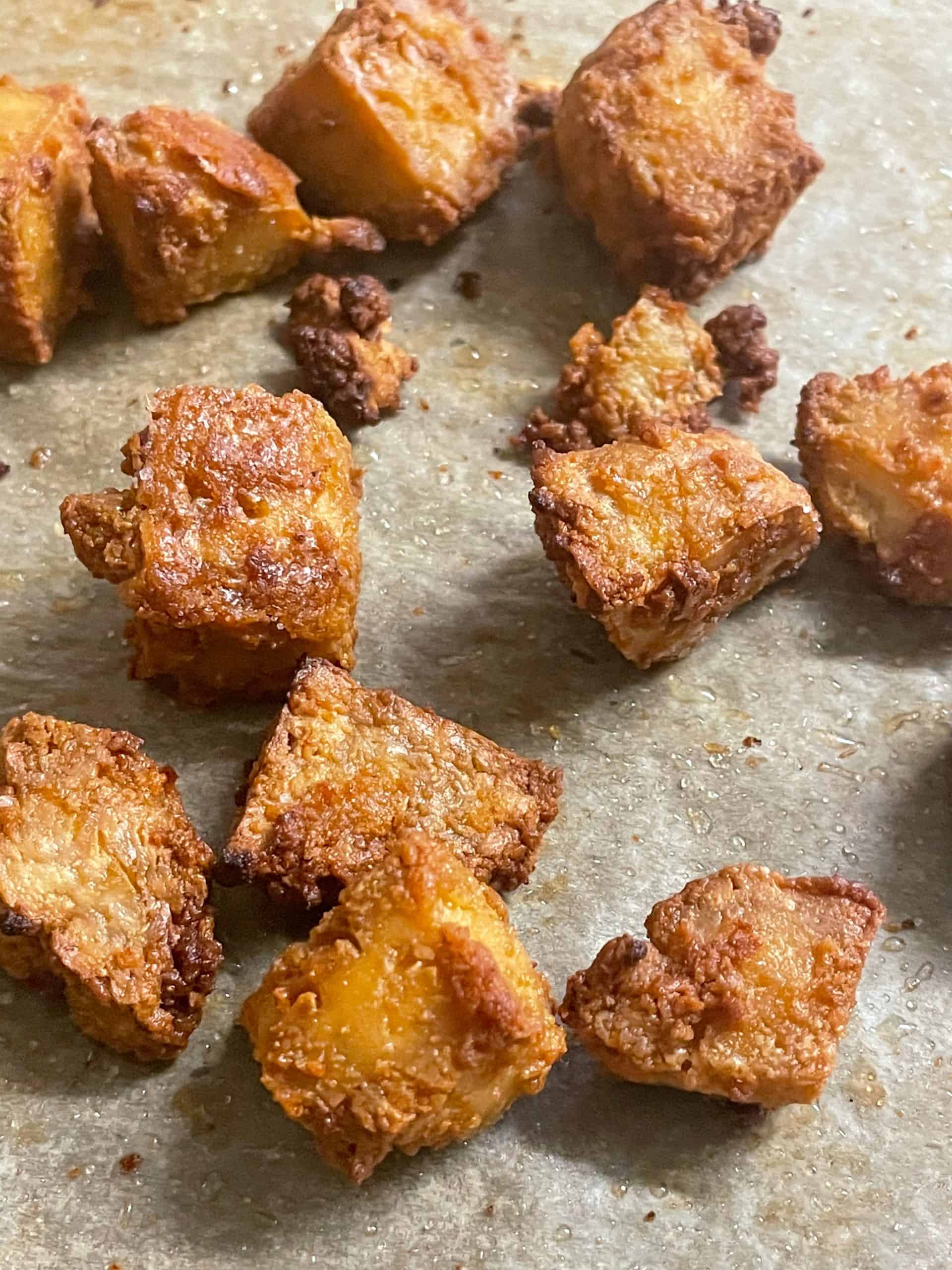 vegan crispy tofu bites on a baking tray featured image.