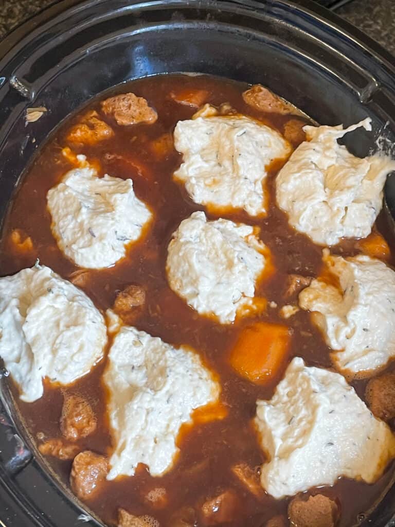 dumplings in slow cooker cooking in stew