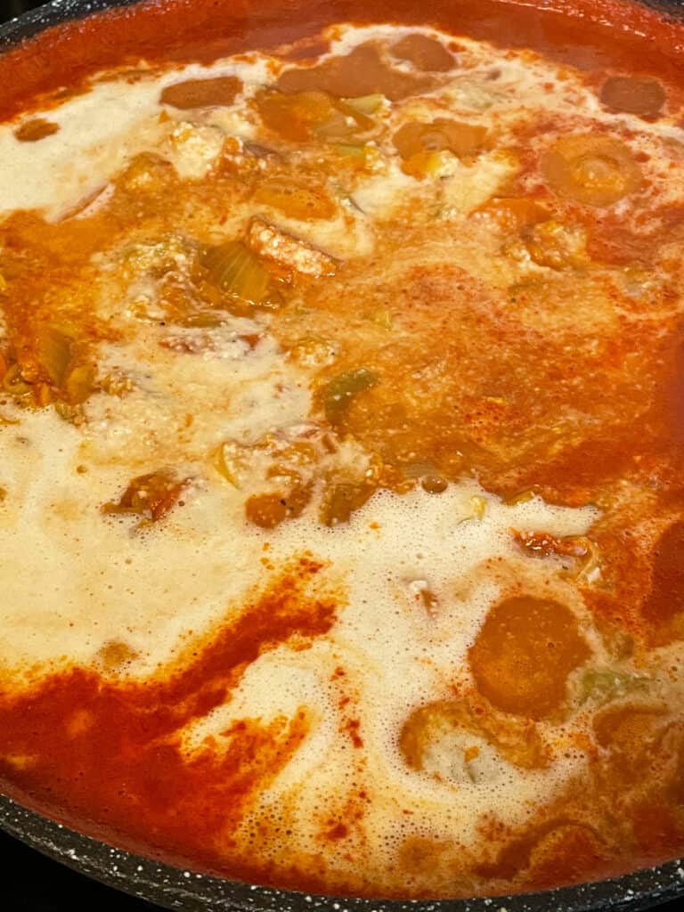 cashew cream added to Moroccan stew cooking on the stove top.