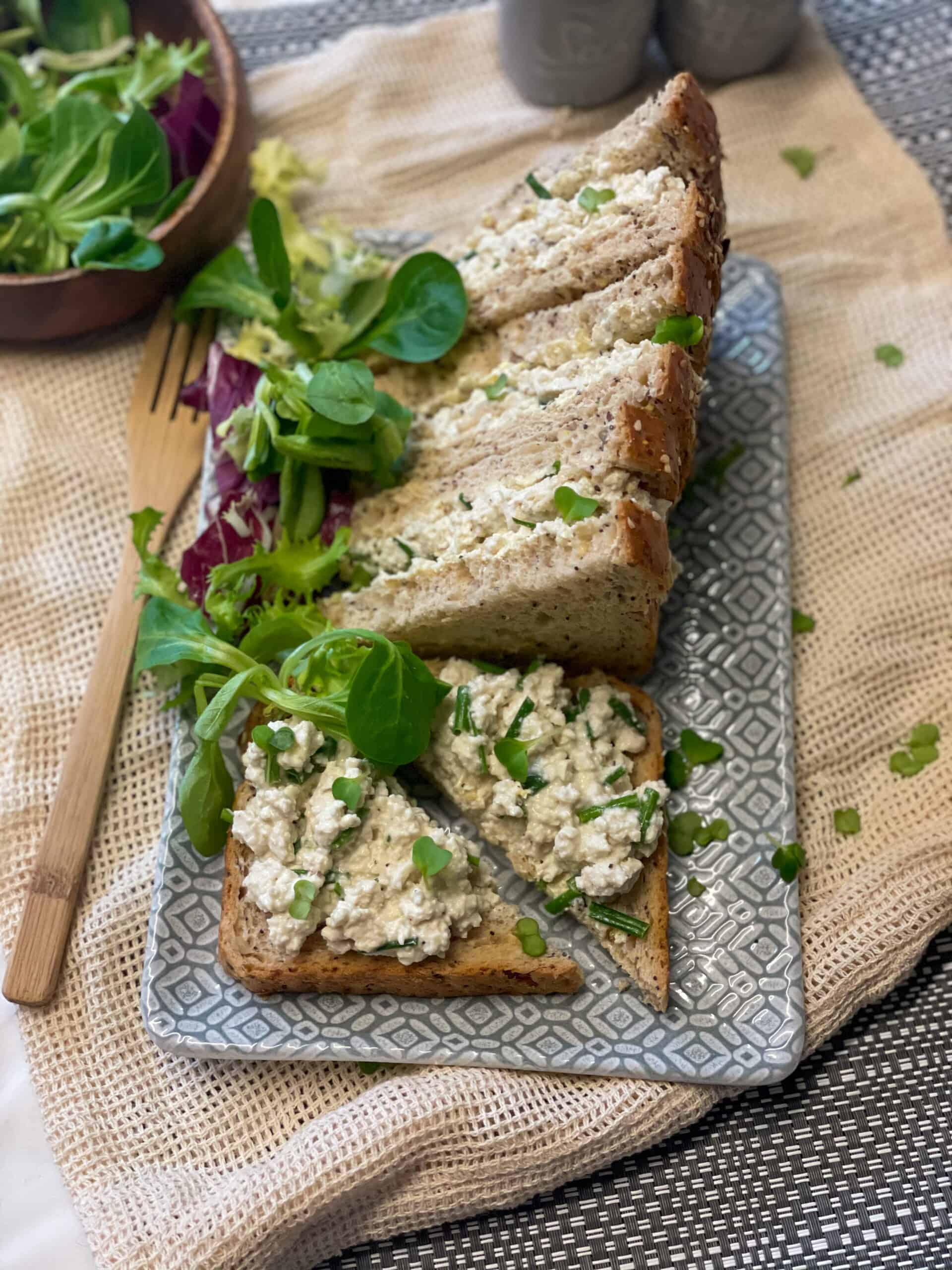 Tofu mayonnaise sandwich on a grey platter.