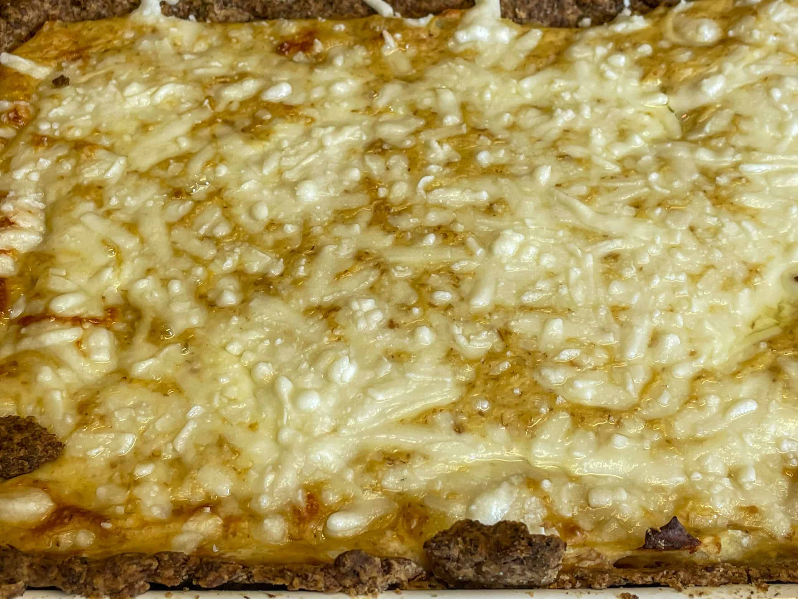 Baked cheese onion and potato pie close up.