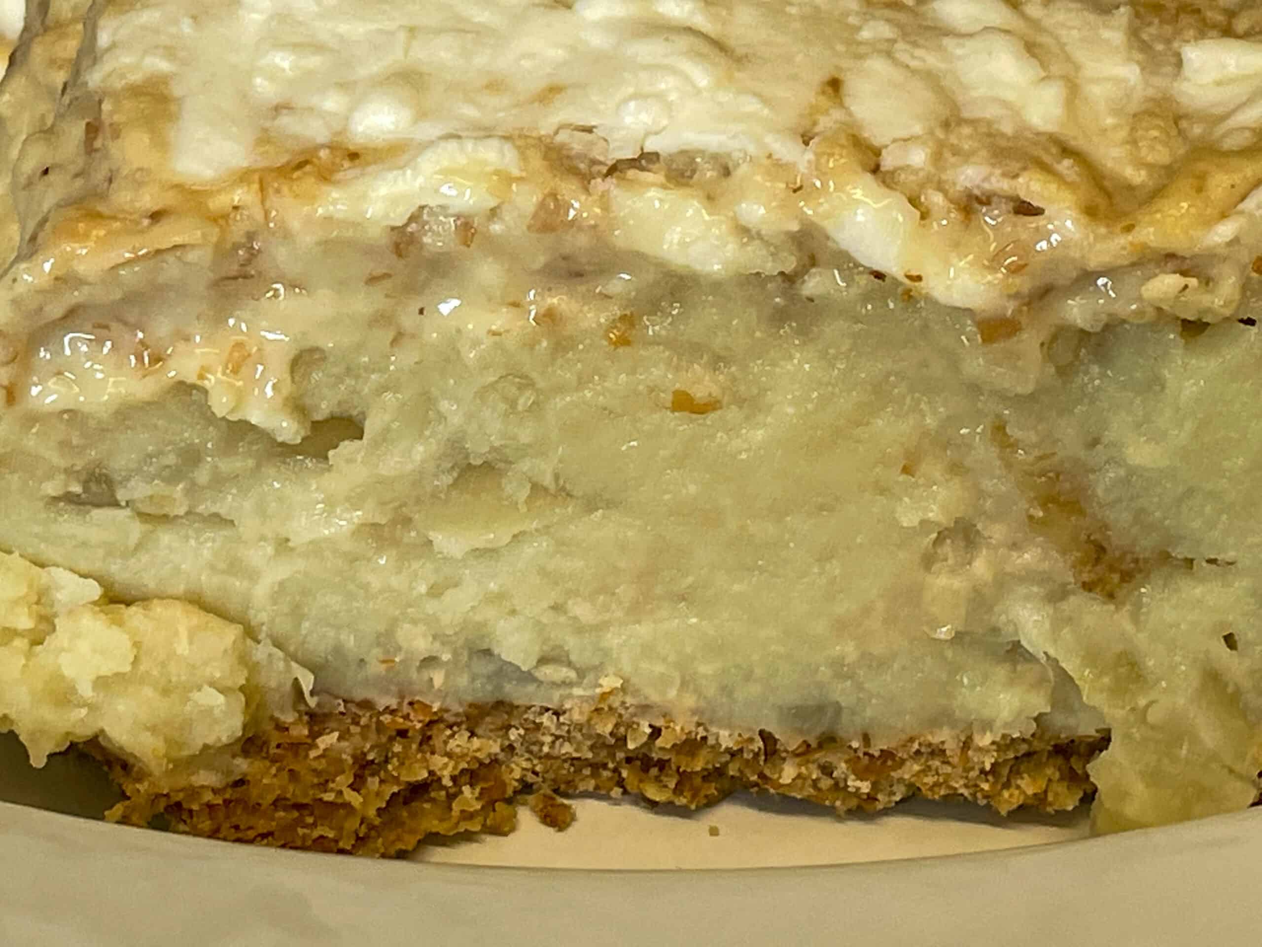 A close up of a slice of pie showing the potato filling and pastry crust.