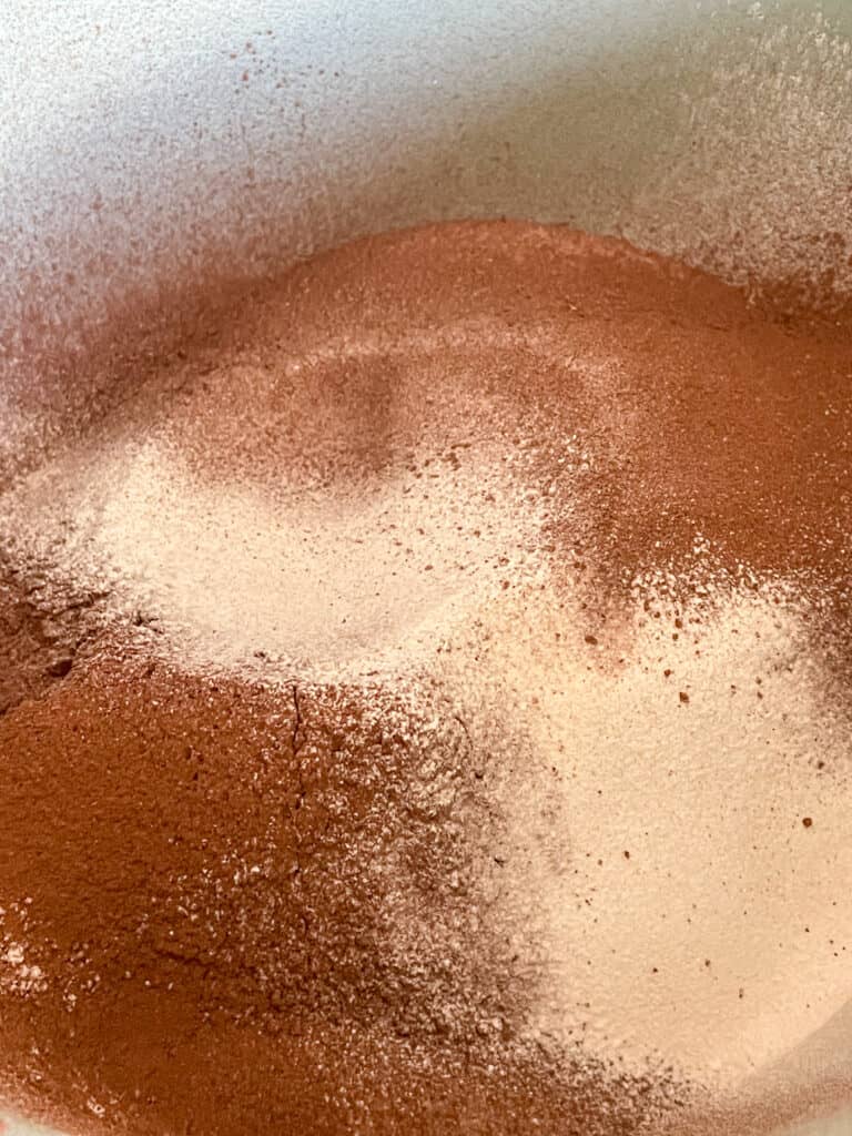 Dry ingredients in a mixing bowl for the chocolate cake.
