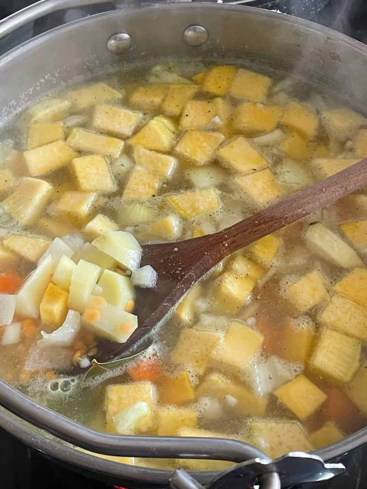 Vegetable stock added to soup pan.