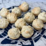 vegan quick dinner rolls cooling on circular wire rack with cream mat underneath with an animal pattern