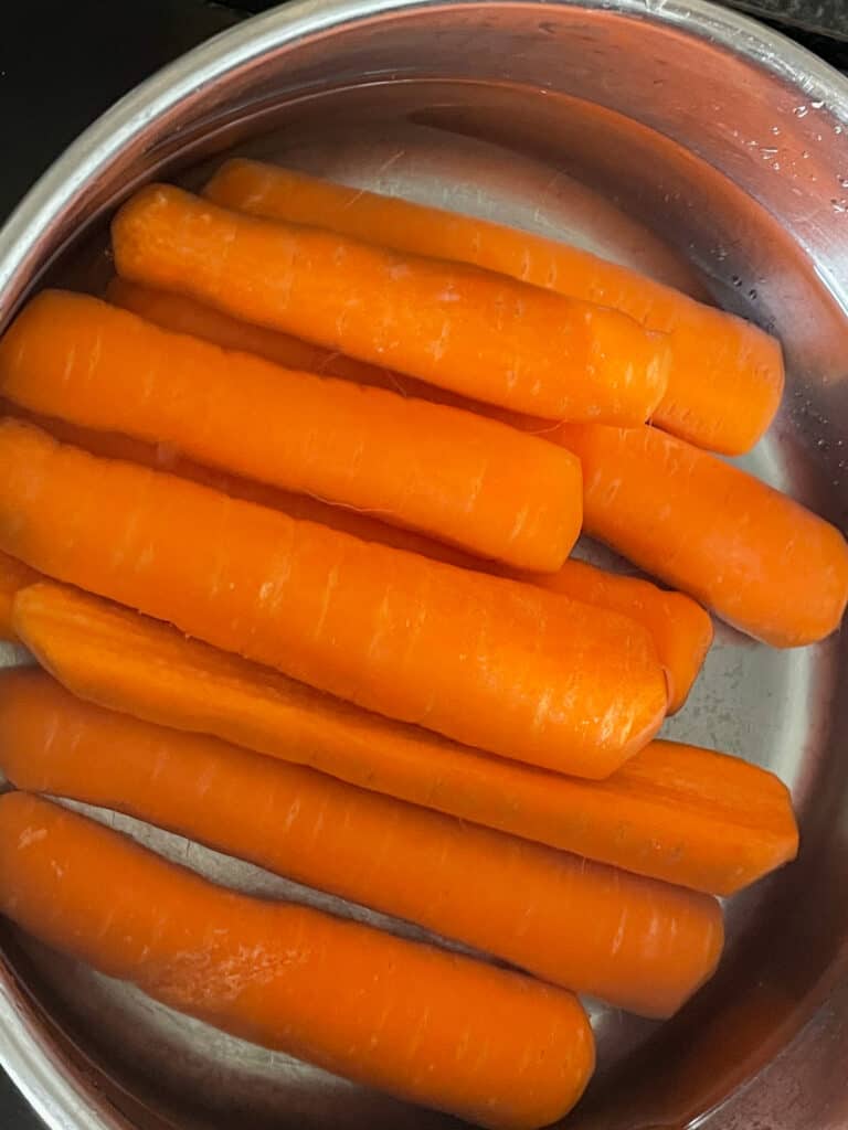 carrot hotdogs in the saucepan ready to cook.