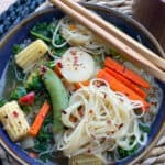 vegan stir fry soup in blue bowl with chop sticks