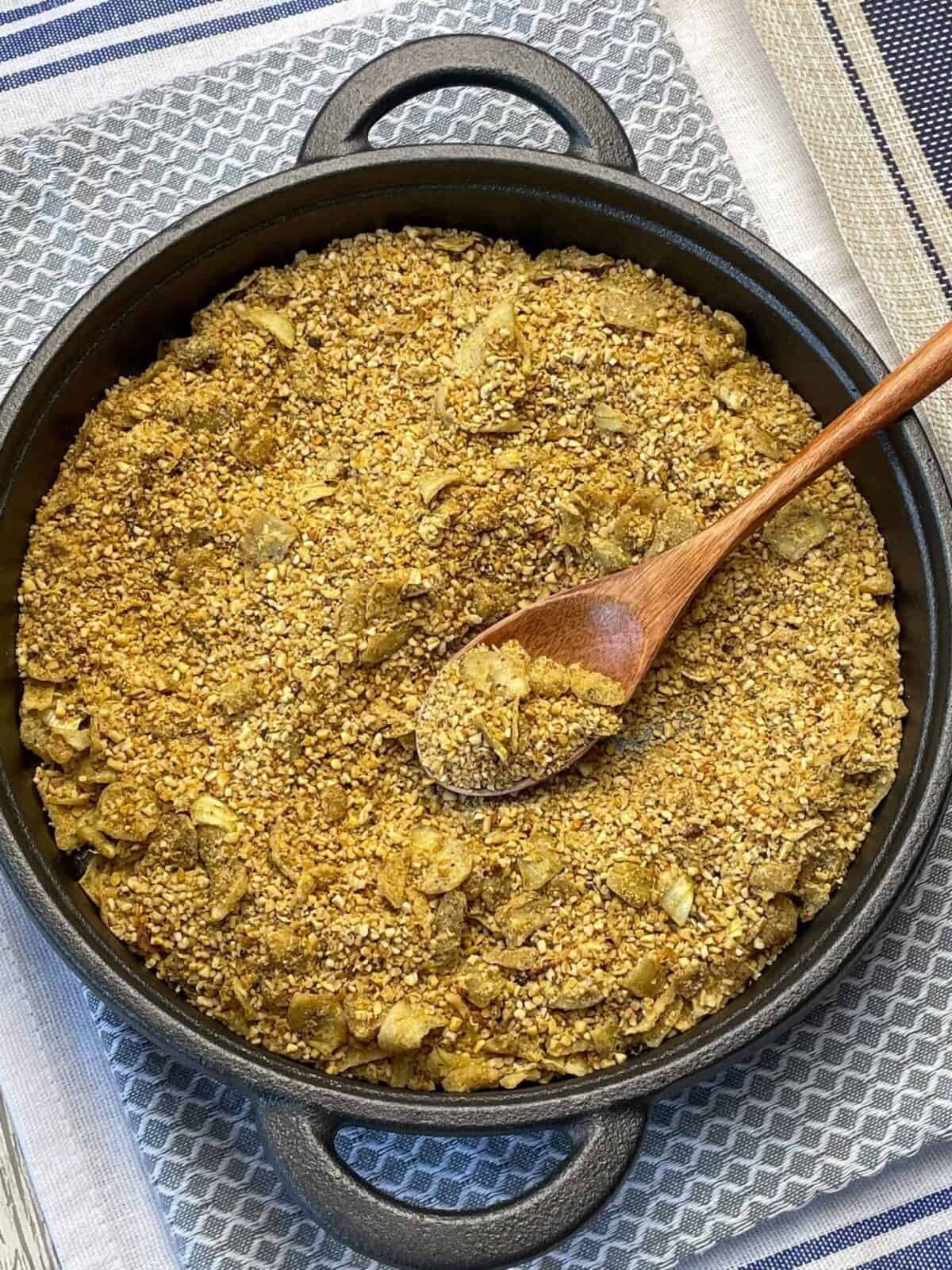 Vegan skirlie toasted and golden, sitting in pan on top of a blue tea towel.