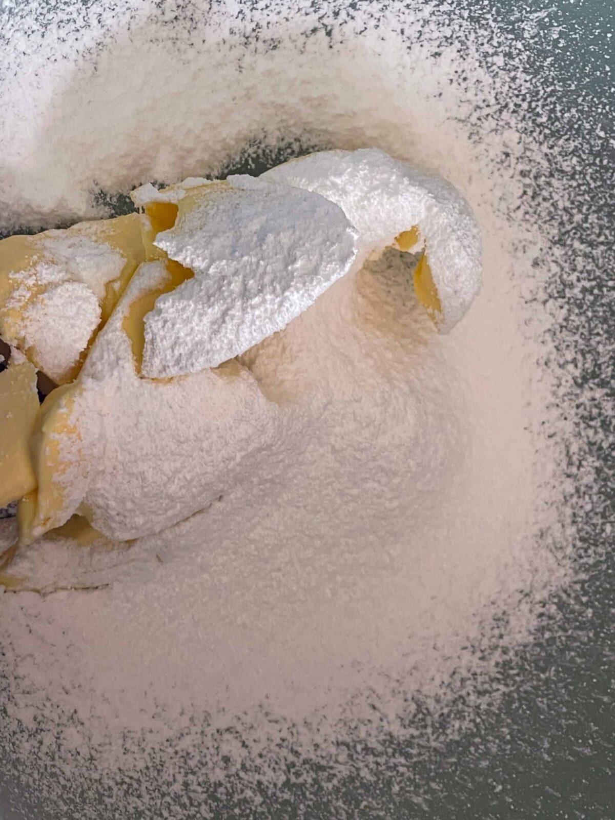 Vegan butter and icing sugar in mixing bowl.