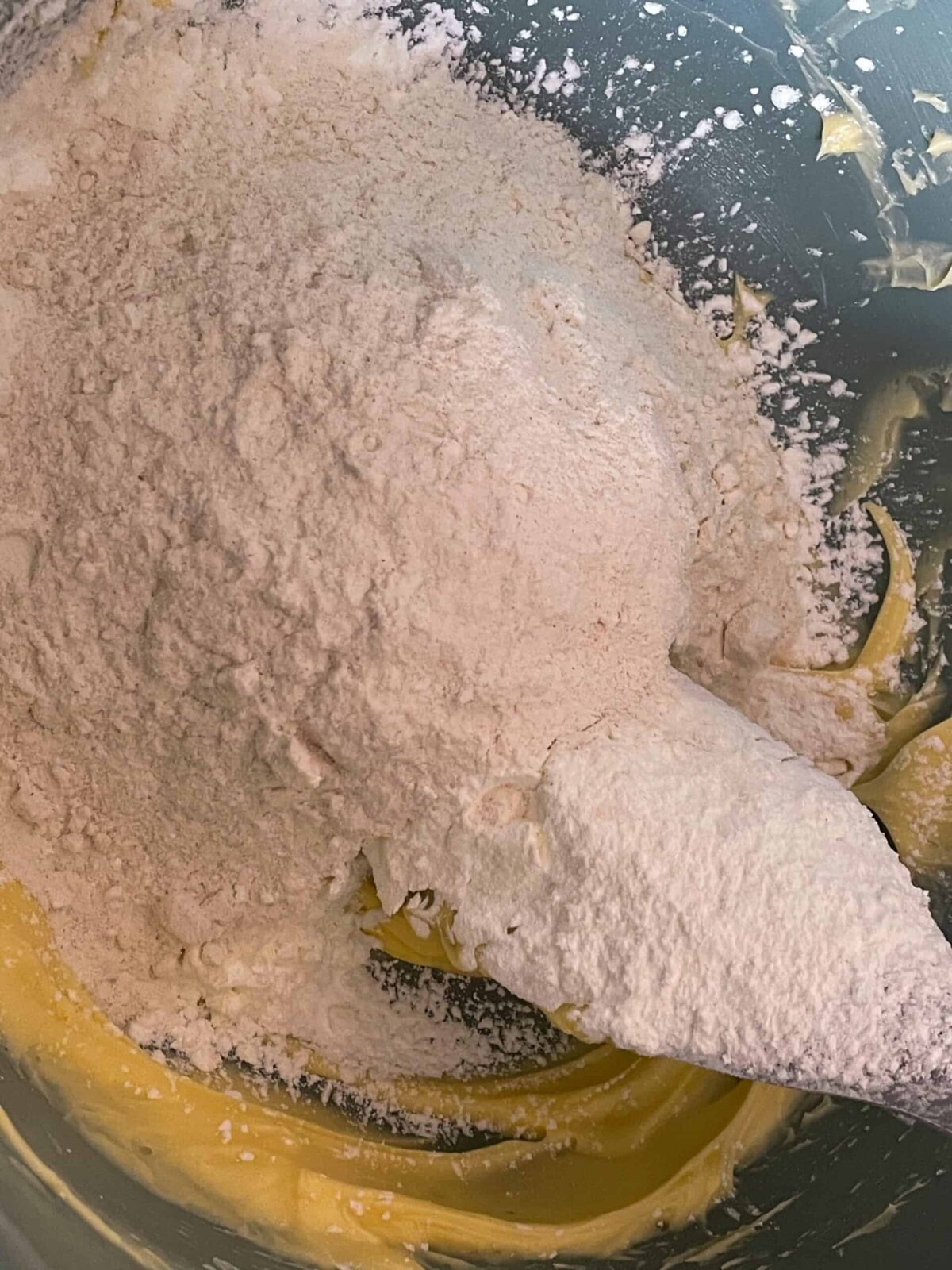 Creamed sugar in mixing bowl with flour added.