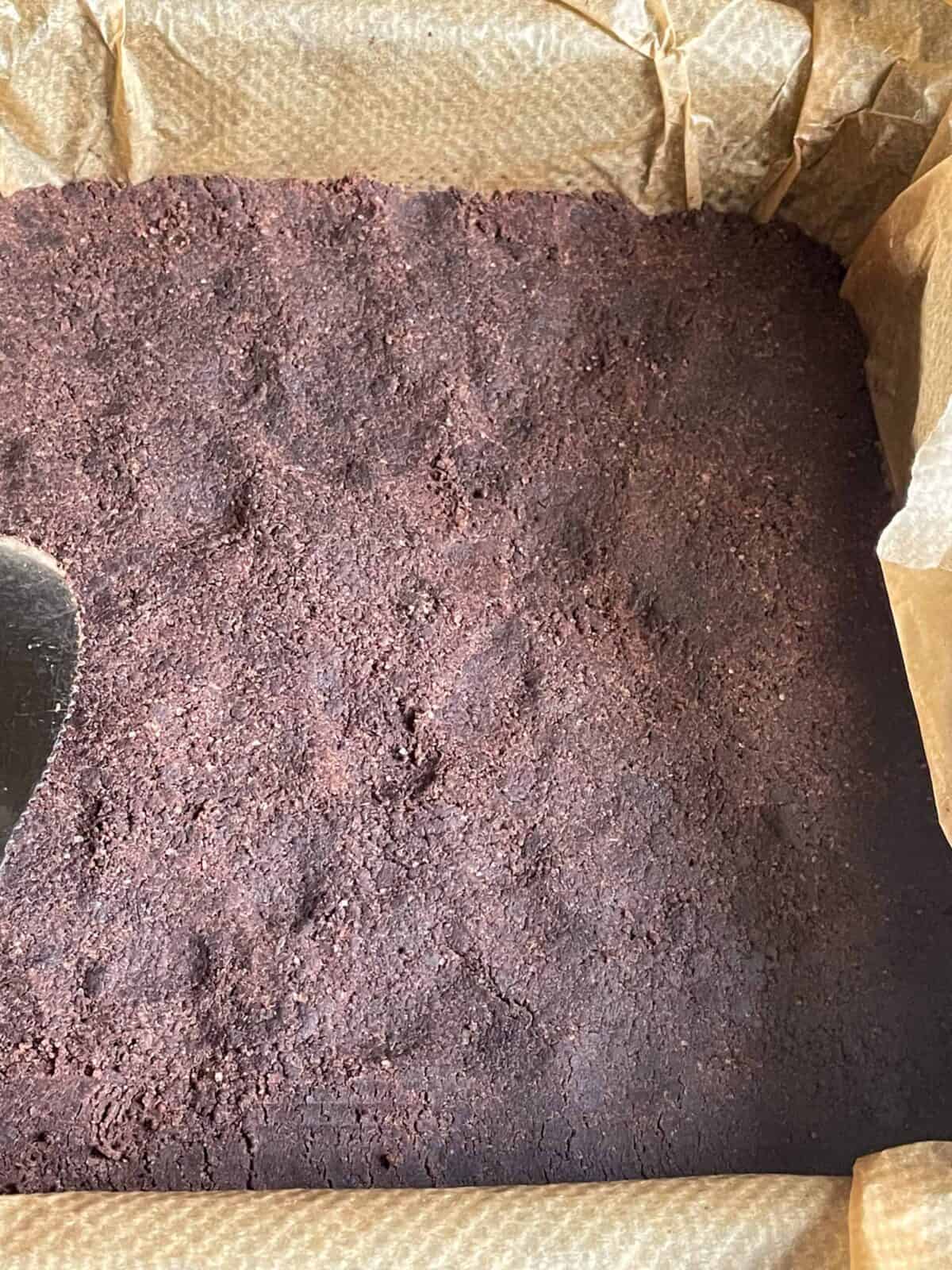 Chocolate mix pressed down firm into baking pan.