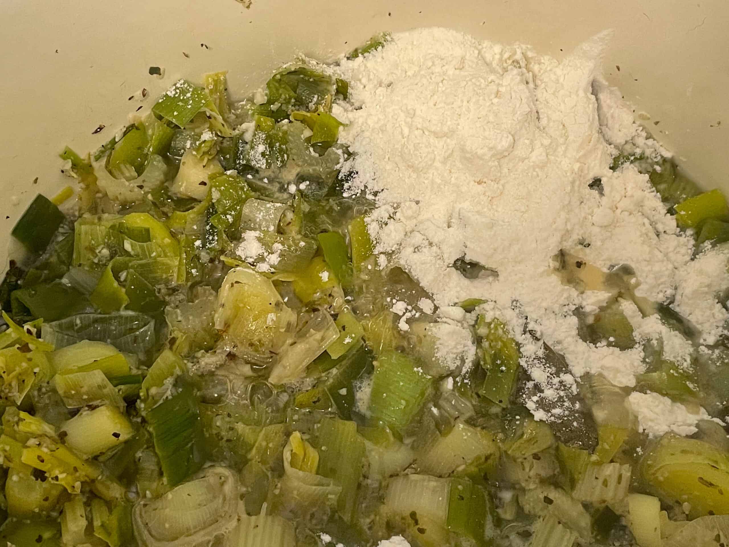 Flour added to sautéed leeks in soup pot.