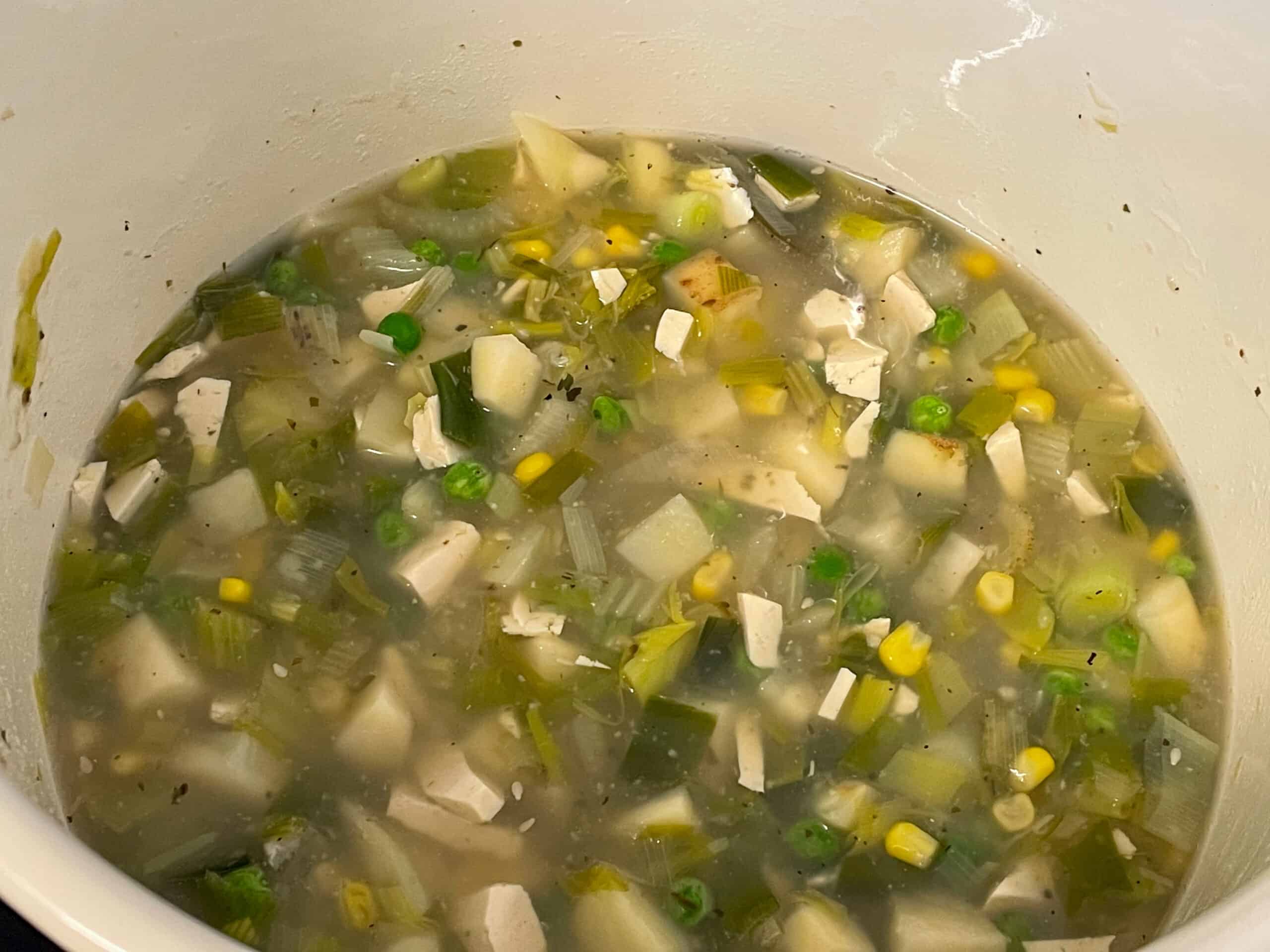 Veggie stock added to veggies in soup pot.