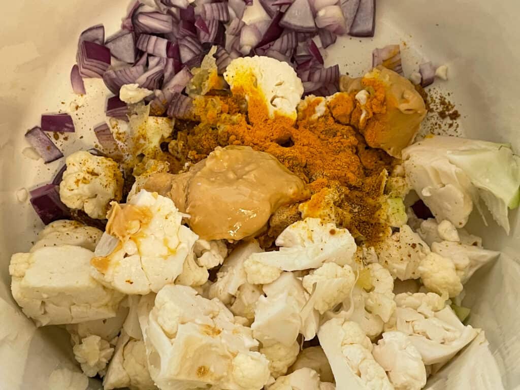 Ingredients for cauliflower soup in a cream enamel stock pot.