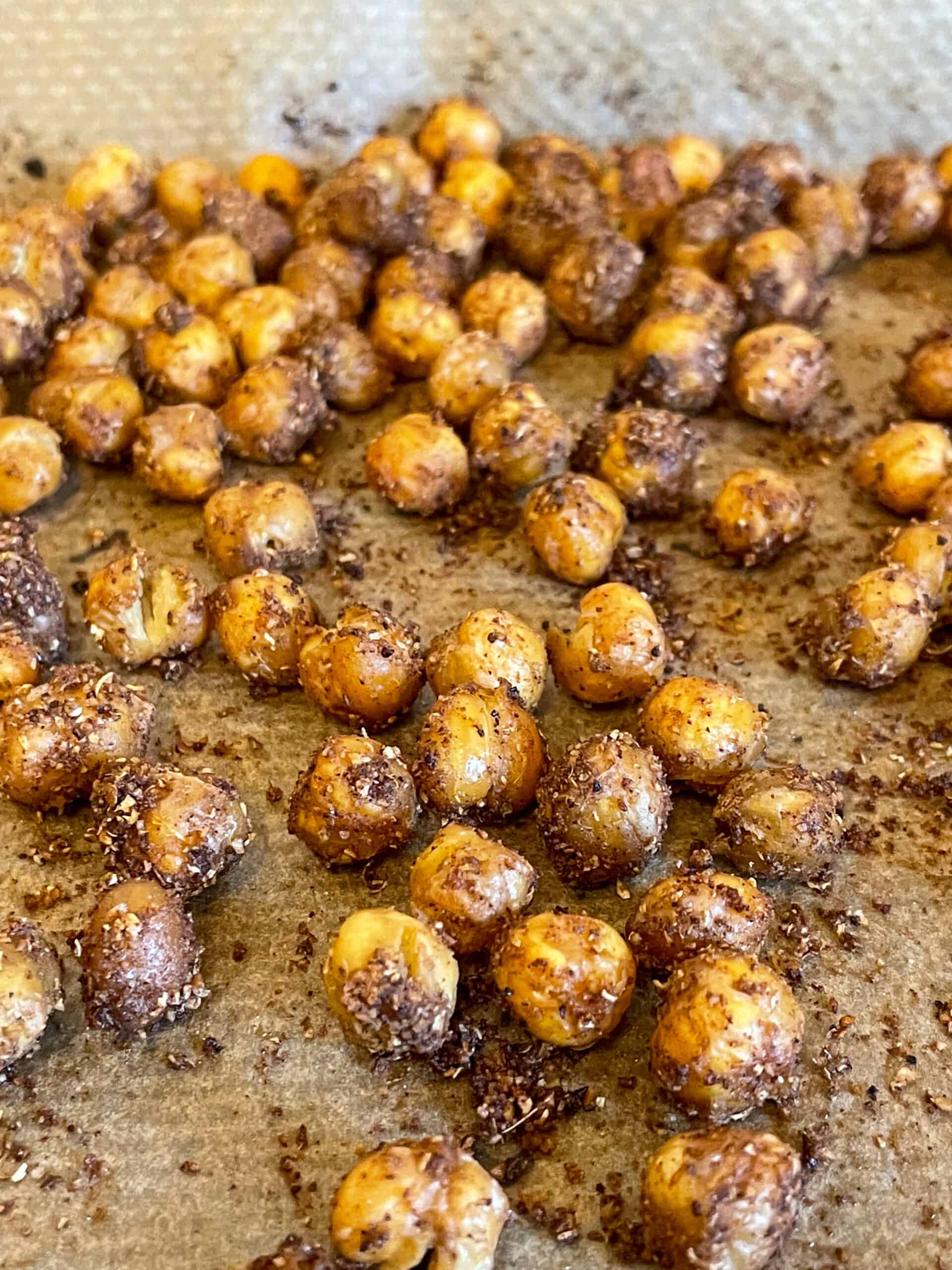 Chickpea croutons on baking tray with greaseproof paper.