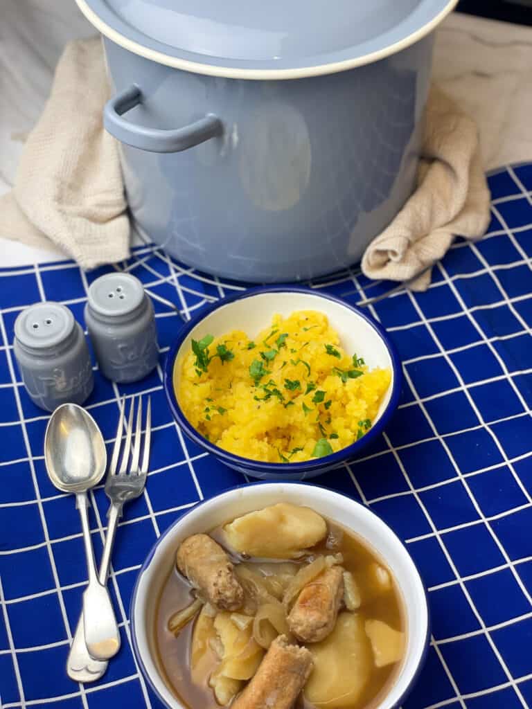 large blue stock-pot, bowl of stovies, bowl of neeps, fork and spoon.