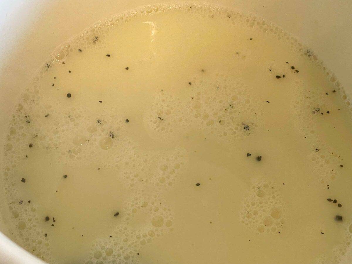 Milk, stock and black pepper corns in large white stock pot for the Irish leek and oatmeal broth.