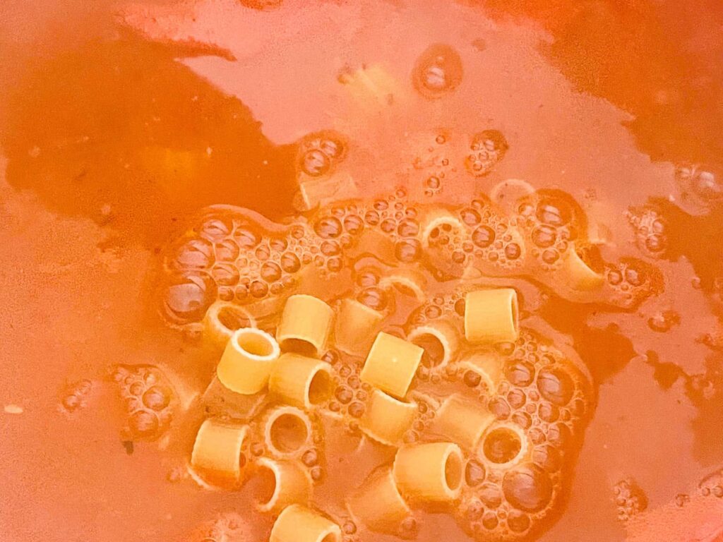 Pasta shapes added to Minestrone soup.