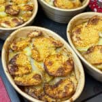 Four pie dishes of hotpot baked and on a baking tray.