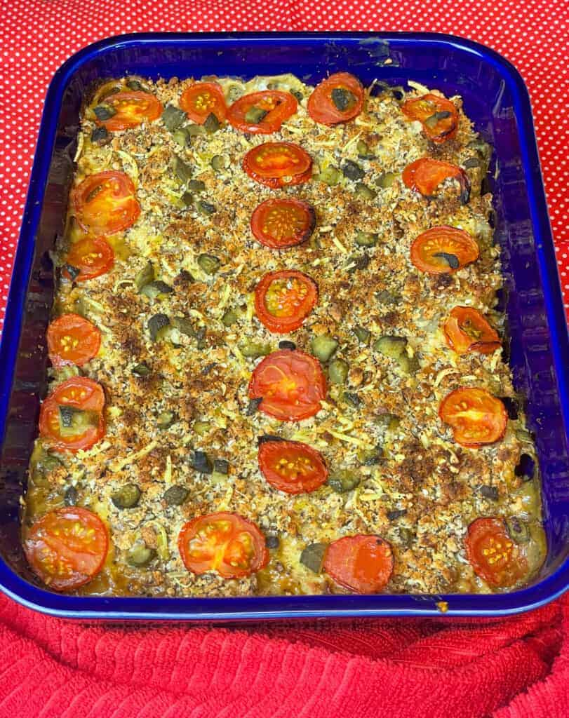 Vegan Hamburger Casserole in blue dish with red background, featured image..