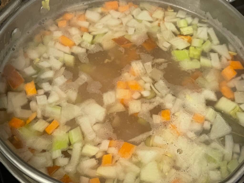 Scotch broth coming to the boil with veggies added.