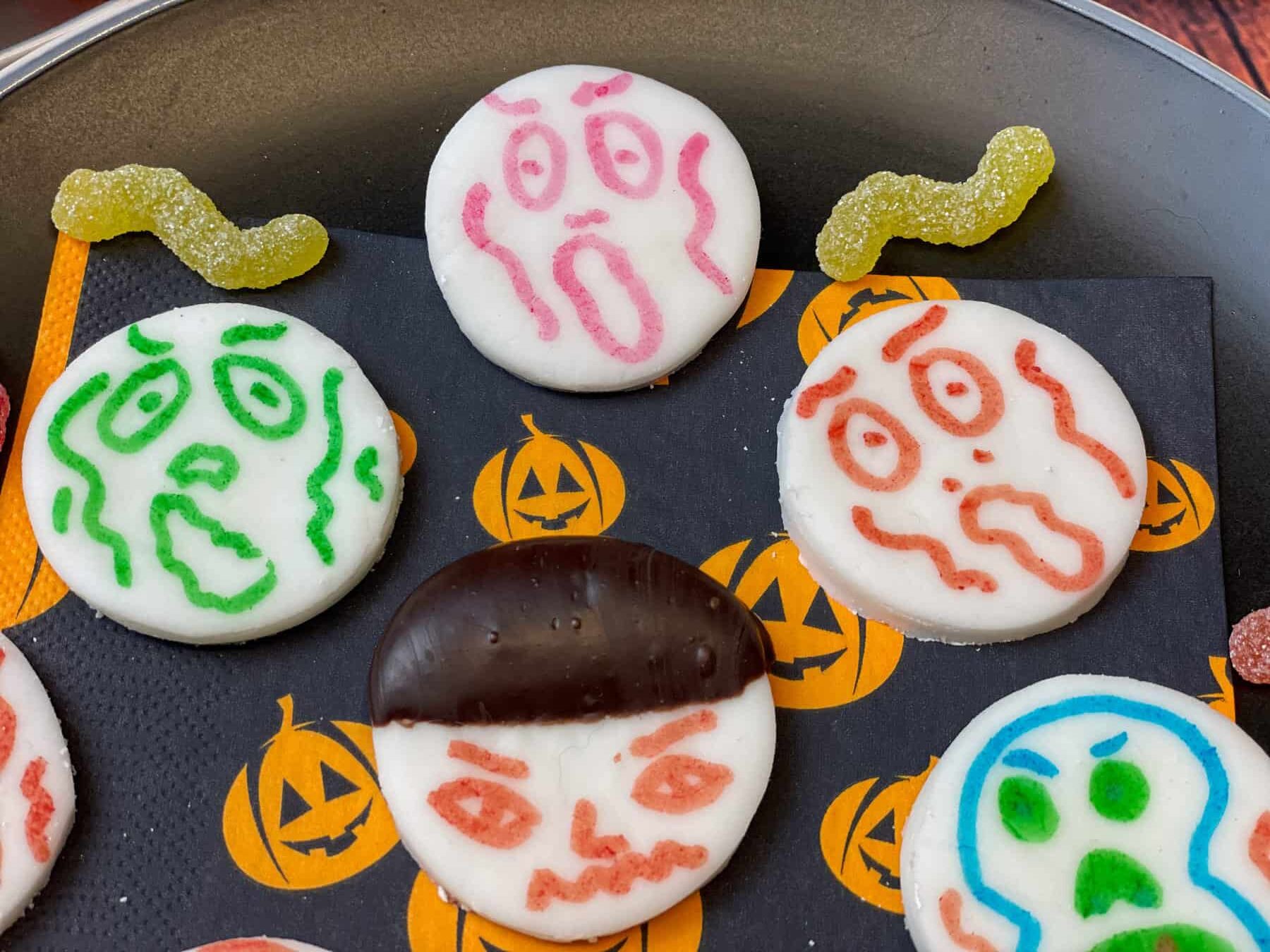 Close up of decorated scary faces on vegan peppermint creams.
