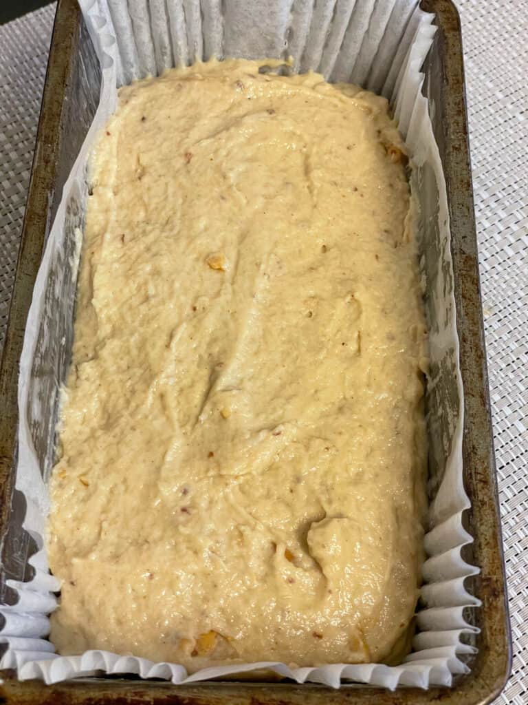 Vegan peanut butter bread raw mix added to loaf pan ready to bake.