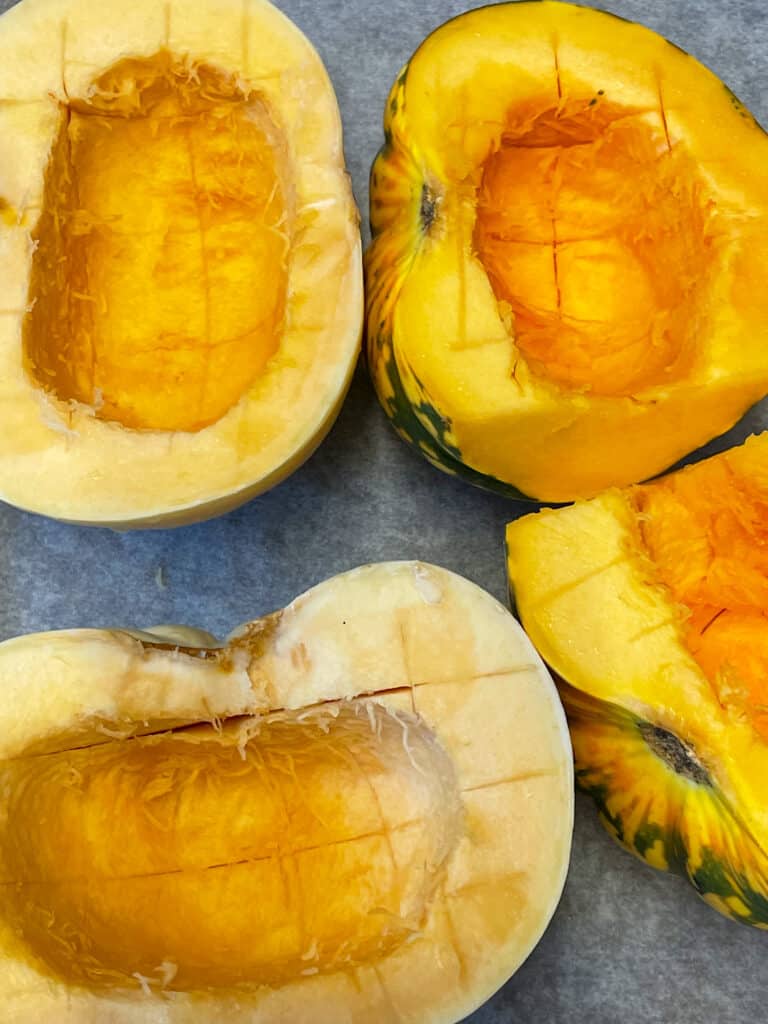 2 acorn squash sliced in half, scored and placed on baking tray.