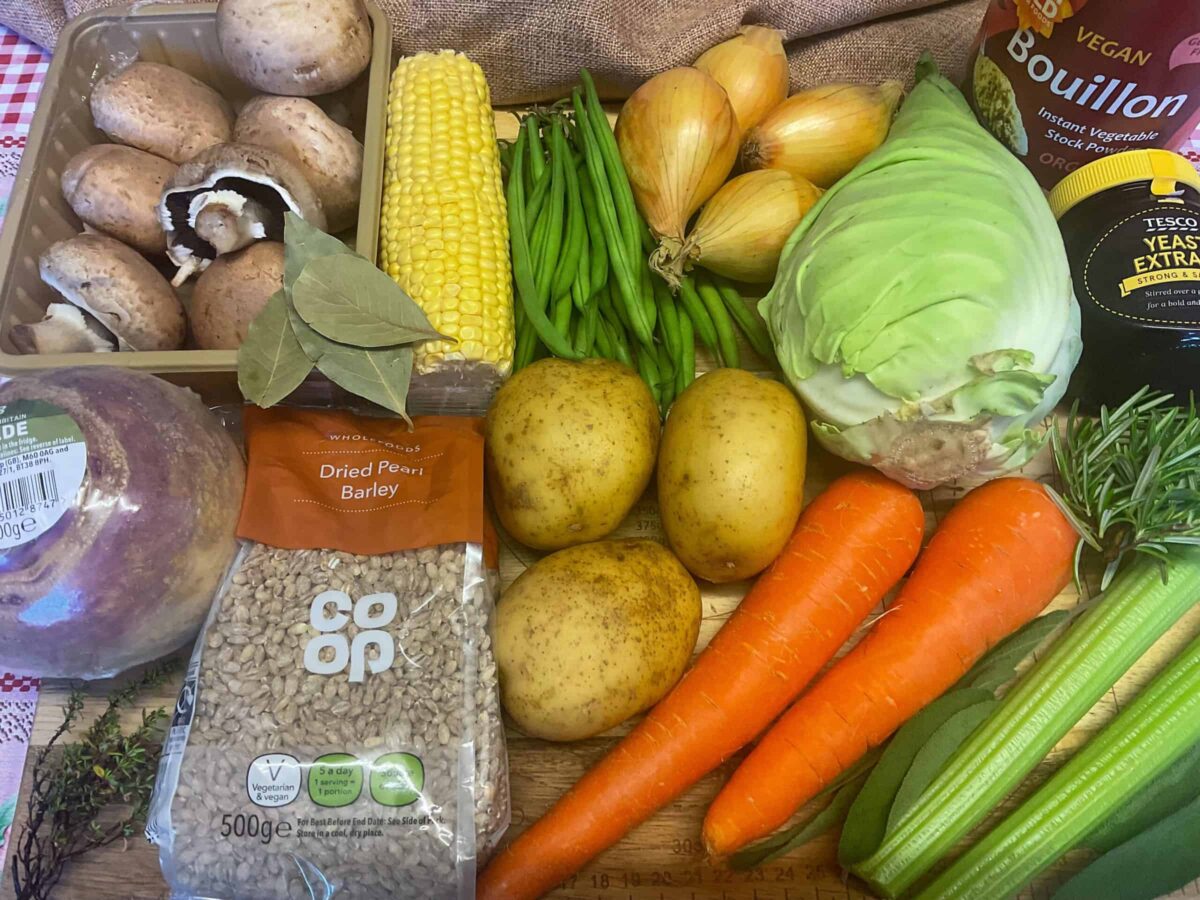 Vegetable stew ingredients on a wooden cutting board.