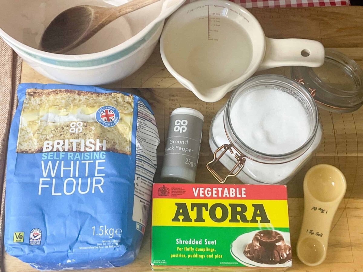 Ingredients for dumplings on a wooden board.