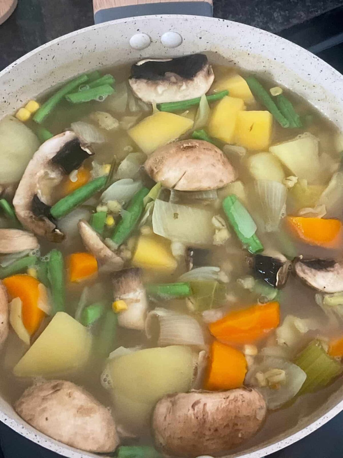 Vegetable stew cooking and ready for dumplings to be added.