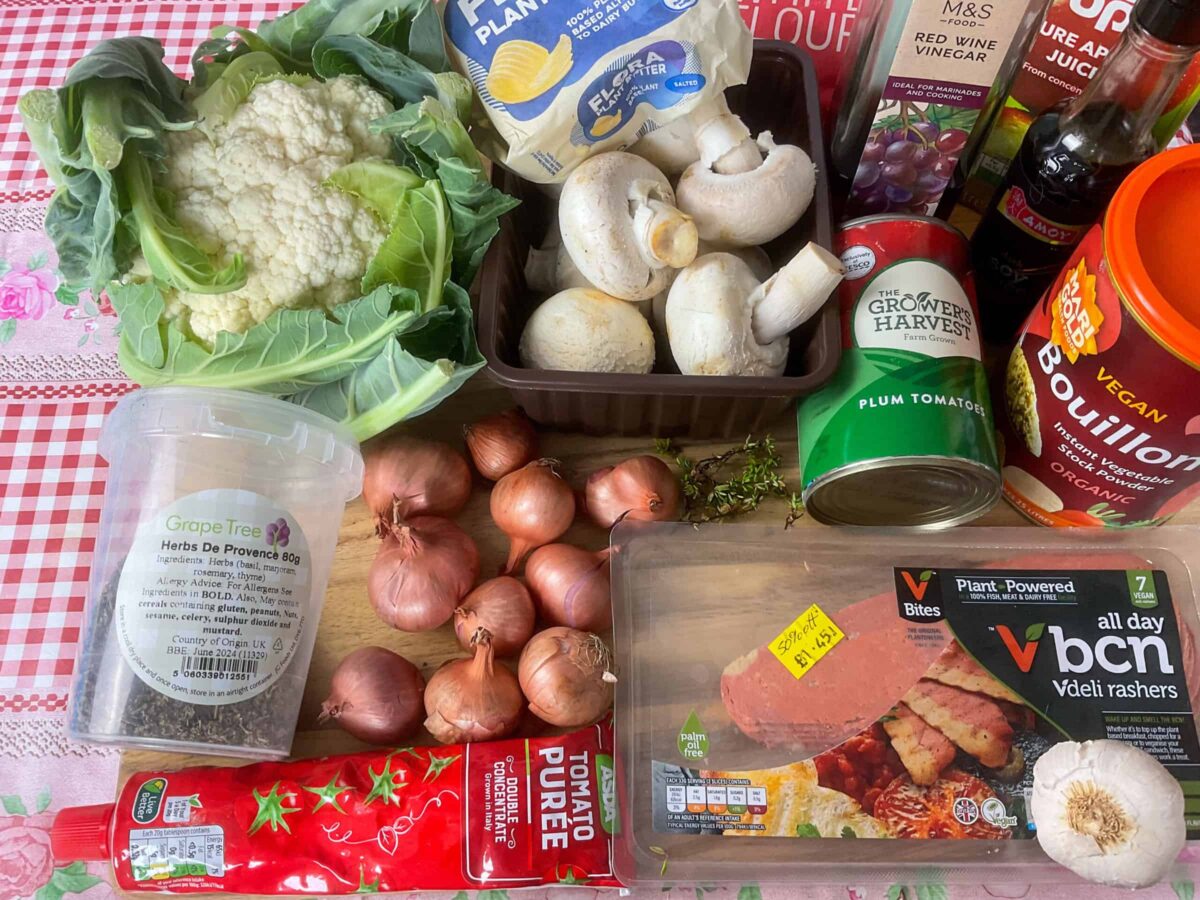 Vegan coq au vin ingredients on a chopping board.