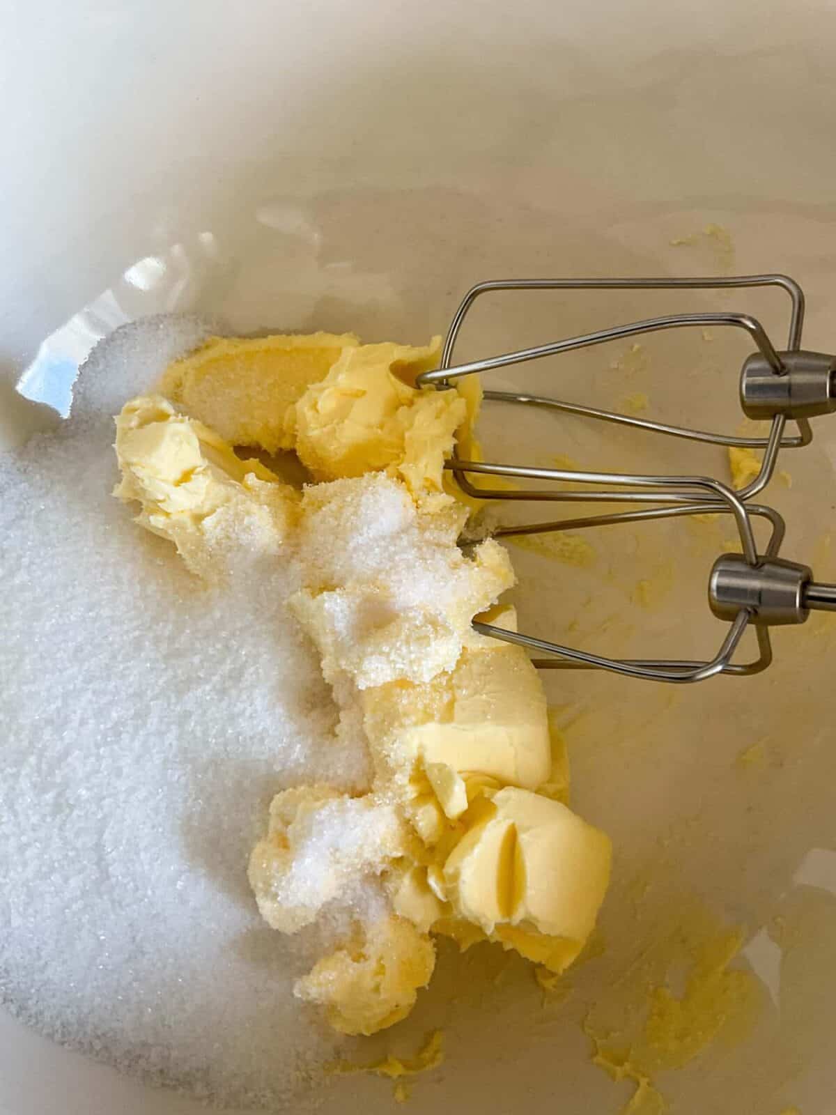 Margarine and sugar in mixing bowl with food whisk beaters.