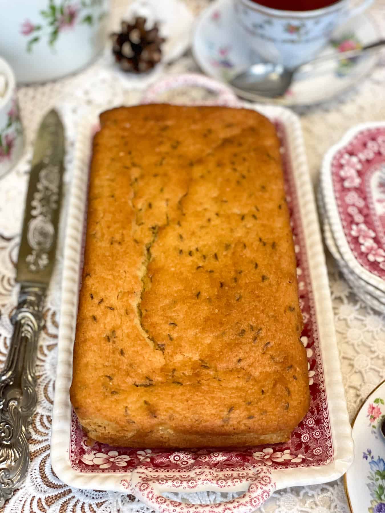 Baked seed cake on serving tray for afternoon tea table.