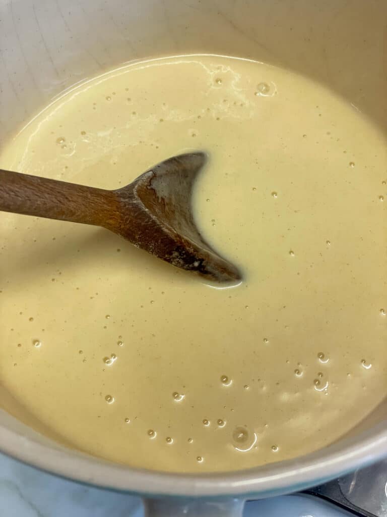 fairy cake batter mixed together with a wooden spoon.