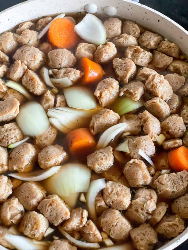 vegan Irish stew cooking in soup pot.