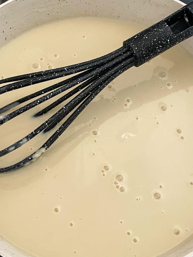 plant milk fully whisked through the roux with whisk.