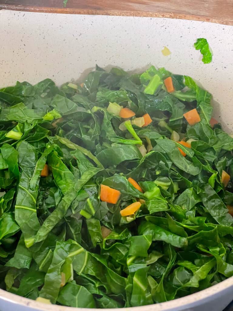 spring greens mixed through the cooking carrots and celery.