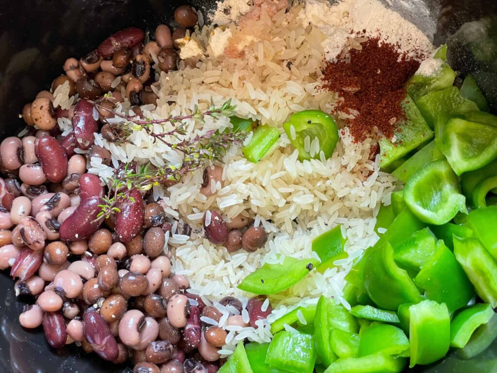 rice and pea ingredients added to the slow cooker.