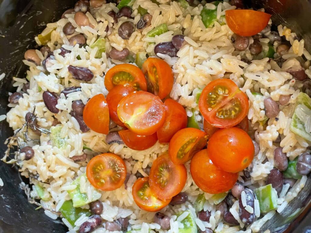 chopped cherry tomatoes added to rice and peas in slow cooker.