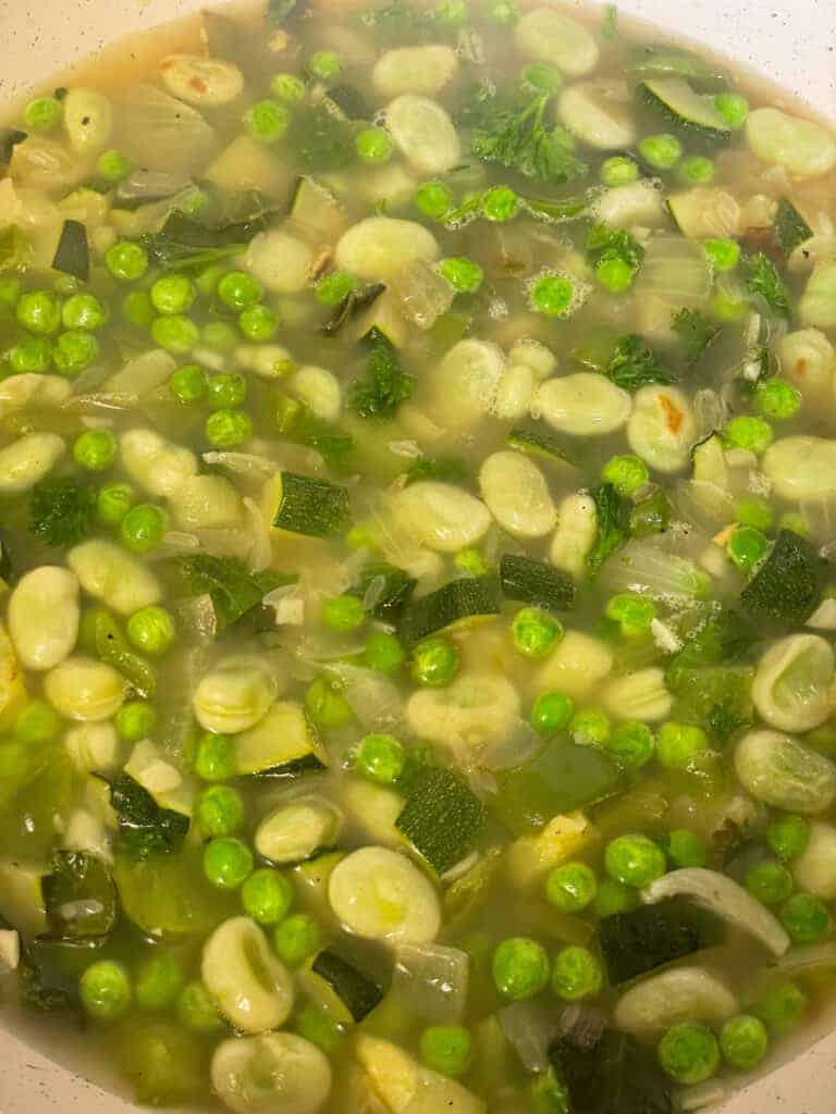veggie stock added to pilaf in pan.