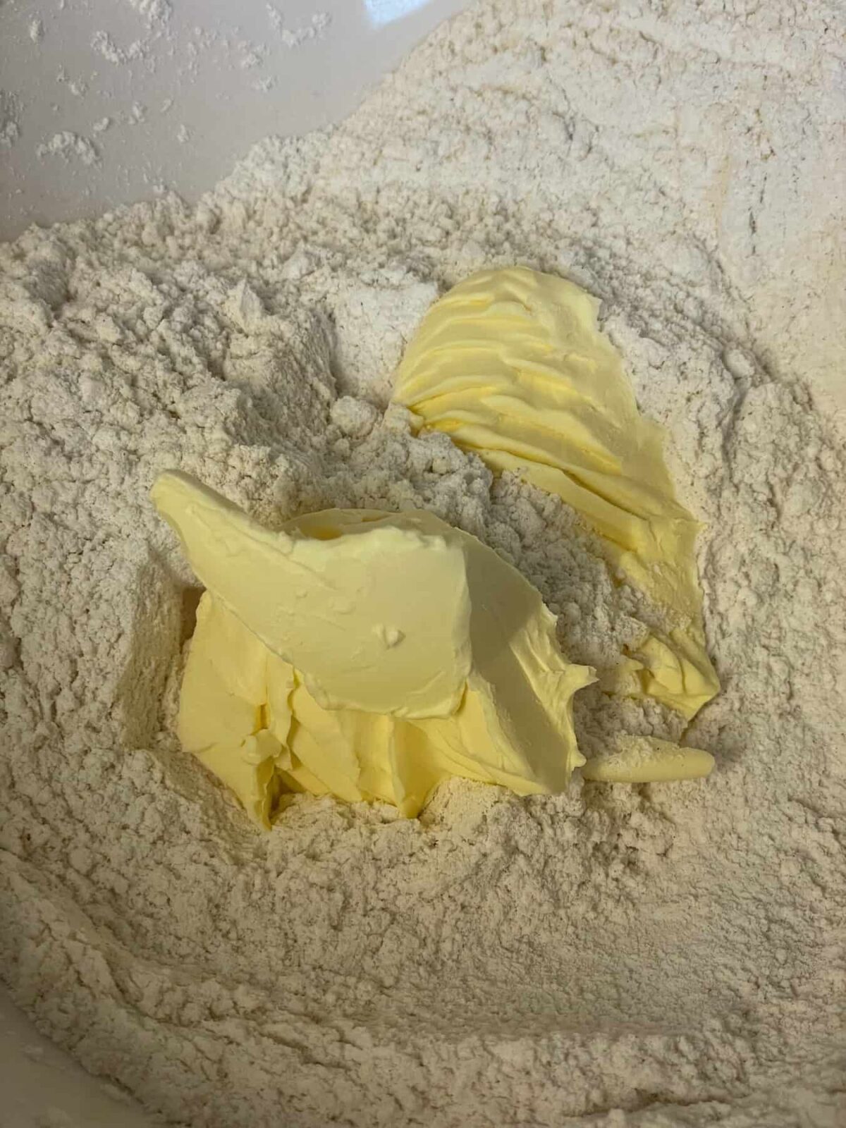 Margarine added to dry ingredients in bowl.