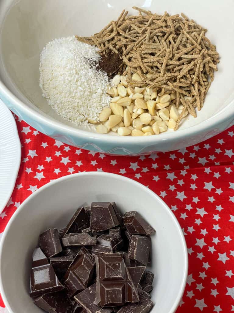 chocolate in small white bowl with larger bowl of ingredients to background, red star background.