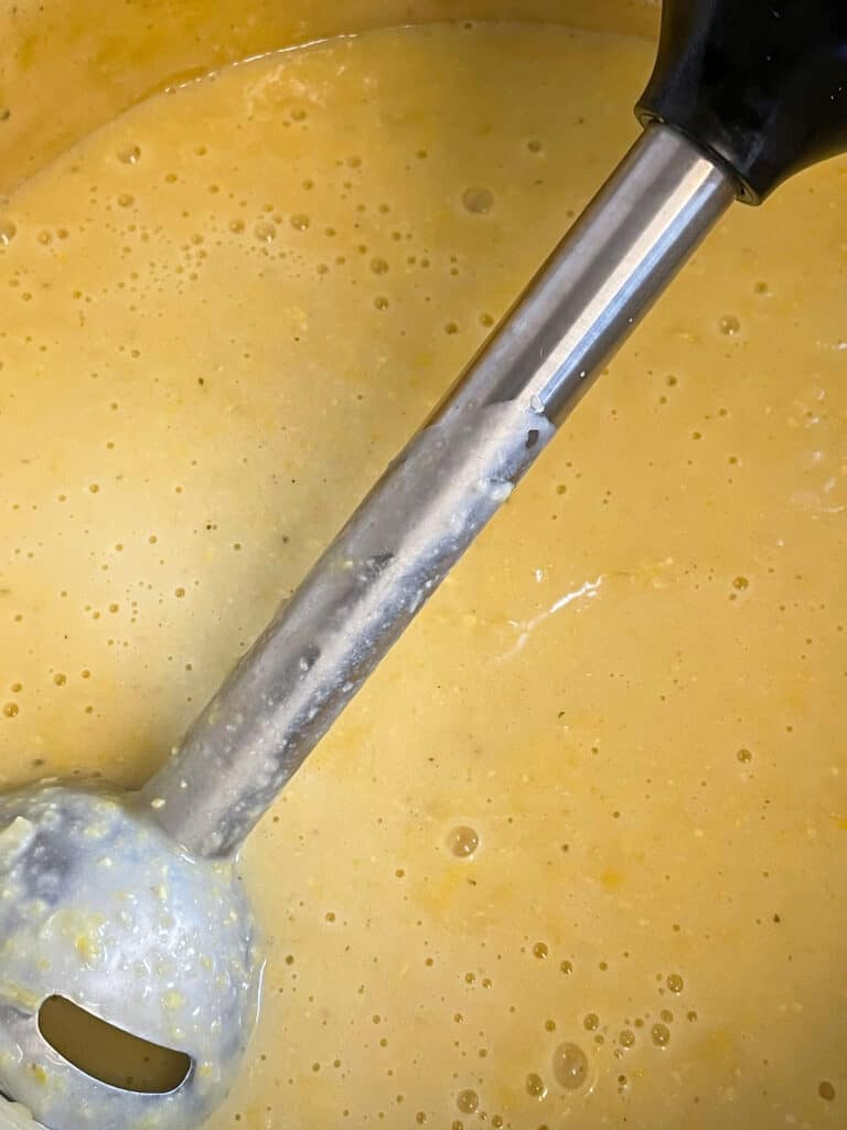 creamed corn soup blended smooth with an immersion blender in the pot.