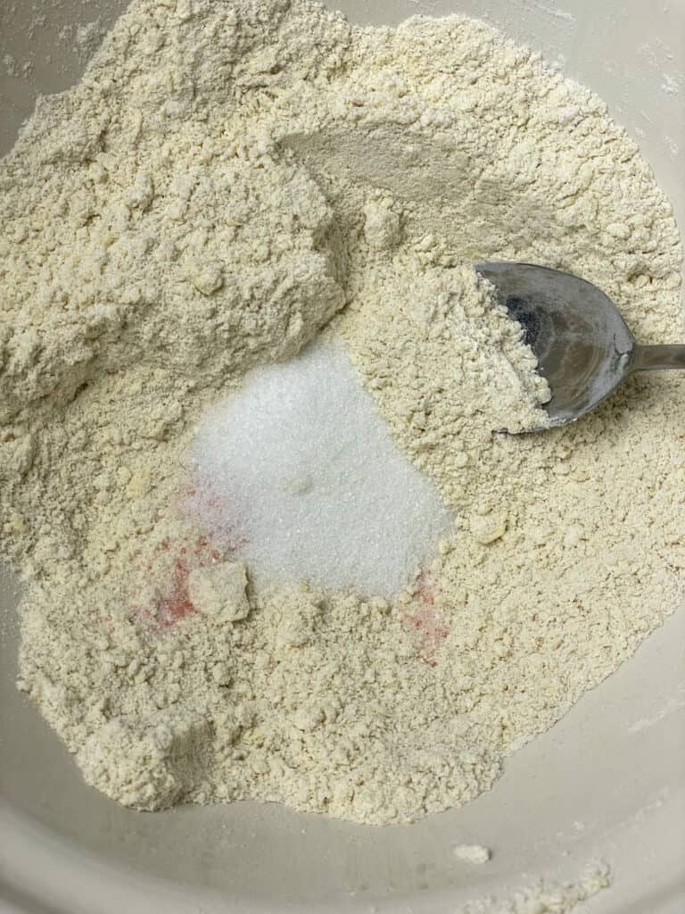 salt and sugar added to dry ingredients in bowl.