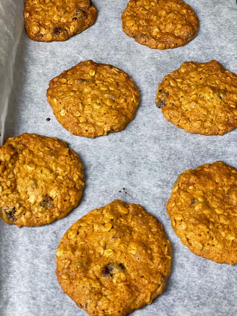 Baked oatmeal raisin cookies on baking tray.