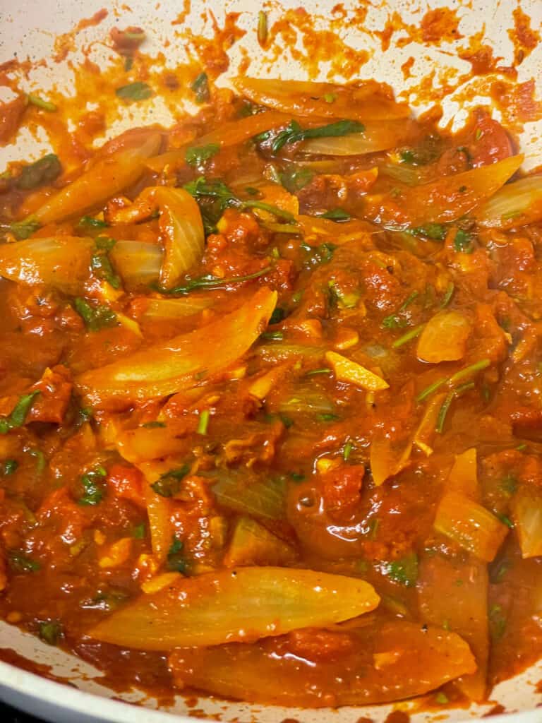 spicy tomato masala sauce cooking in pan.
