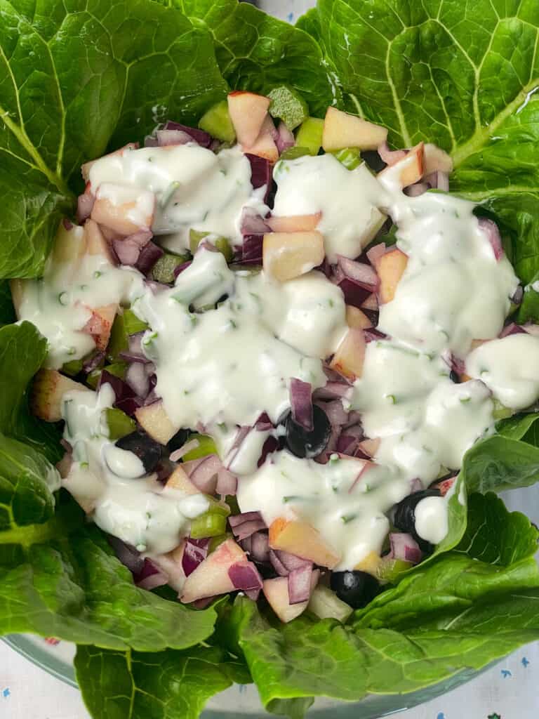 last layer of diced fruit and veggies added to salad lined bowl and last layer of dressing added.