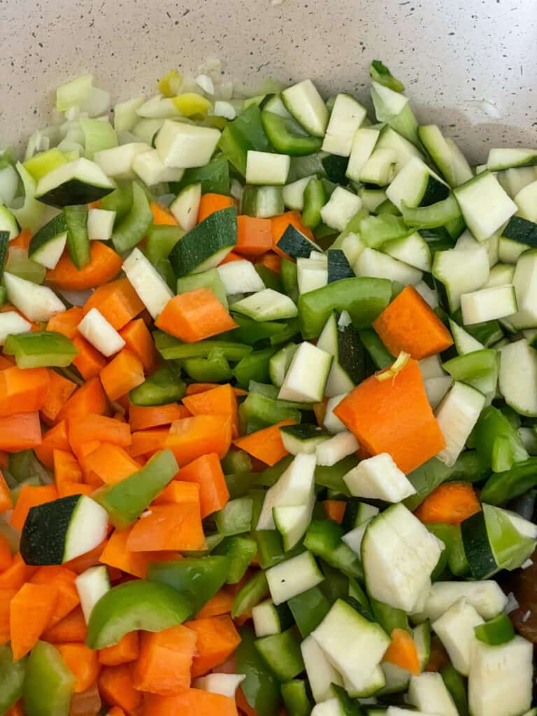 diced veggies in soup pot.