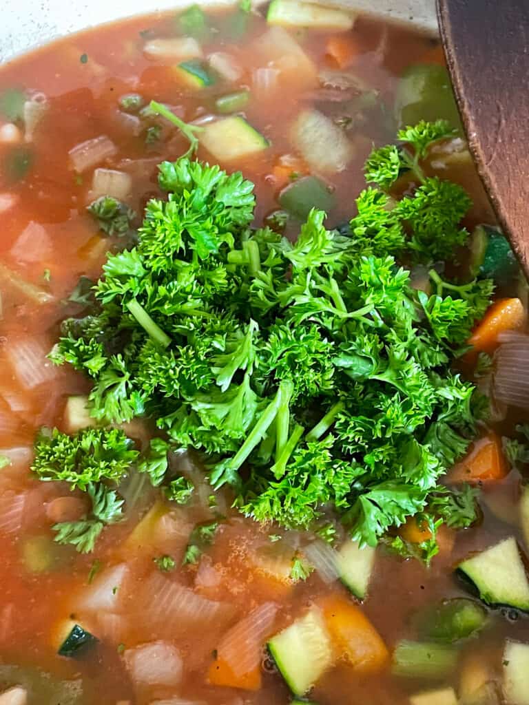 kale added to cabbage and bean soup.